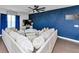 Bright living room features a ceiling fan and an accent wall at 109 Paulownia Cir, Mcdonough, GA 30253