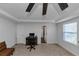 Spacious primary bedroom with an office area featuring a ceiling fan, and neutral tones offers a calming retreat at 109 Paulownia Cir, Mcdonough, GA 30253