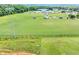 Wide aerial shot of multi-use sports field with sports equipment and lighting near an undeveloped lot at 109 Paulownia Cir, Mcdonough, GA 30253