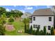 A lush green backyard with trees and shrubs, featuring a cozy fire pit at 319 Hayden Cir, Woodstock, GA 30189