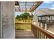 Relaxing outdoor balcony featuring wood floors, pergola, and railing overlooking a green lawn with trees at 319 Hayden Cir, Woodstock, GA 30189