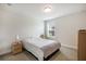 Cozy bedroom featuring carpeted floors, a window with blinds, and a nightstand with a lamp at 319 Hayden Cir, Woodstock, GA 30189