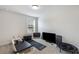 Spacious bonus room with natural light, a black exercise mat, and a variety of exercise equipment at 319 Hayden Cir, Woodstock, GA 30189