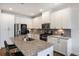 Modern kitchen featuring granite countertops, stainless steel appliances, and a large island with bar seating at 319 Hayden Cir, Woodstock, GA 30189