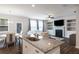 Open-concept kitchen with granite island, stainless appliances, seamlessly flowing into the dining and living areas at 319 Hayden Cir, Woodstock, GA 30189