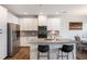 Modern kitchen featuring granite countertops, stainless steel appliances, and a large island with bar seating at 319 Hayden Cir, Woodstock, GA 30189