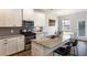 Modern kitchen featuring granite countertops, stainless steel appliances, and a large island with bar seating at 319 Hayden Cir, Woodstock, GA 30189