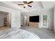Bright and airy main bedroom featuring carpet floors, ceiling fan, and access to a private balcony at 319 Hayden Cir, Woodstock, GA 30189