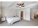 Comfortable main bedroom with tray ceiling, ceiling fan, neutral colors, and access to the ensuite bath and closet at 319 Hayden Cir, Woodstock, GA 30189