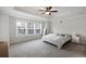 Spacious main bedroom featuring neutral walls, carpet flooring, a ceiling fan, and windows for natural light at 319 Hayden Cir, Woodstock, GA 30189