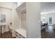 Convenient mudroom featuring built-in bench, hooks, and storage cubbies adjacent to a half bathroom and kitchen at 319 Hayden Cir, Woodstock, GA 30189