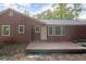This house has a back wooden deck, a door, and many windows. The house has brown siding at 4039 Tanglewood Rd, Snellville, GA 30039