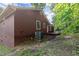 This house has brown siding and a deck. An air conditioning unit sits near the house at 4039 Tanglewood Rd, Snellville, GA 30039