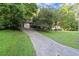 Charming home with a long driveway and lush green lawn at 4039 Tanglewood Rd, Snellville, GA 30039