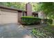 Exterior of the home featuring a garage, driveway, and landscaped yard at 4039 Tanglewood Rd, Snellville, GA 30039