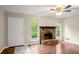 Bright living room boasts a stone fireplace and hardwood floors at 4039 Tanglewood Rd, Snellville, GA 30039