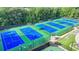 Aerial view of tennis courts surrounded by lush greenery at 1635 Lake Heights Cir, Dacula, GA 30019