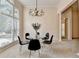 Bright dining room with large windows, a modern chandelier, and neutral walls at 1635 Lake Heights Cir, Dacula, GA 30019