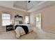 Cozy main bedroom boasts natural light, neutral walls, and a comfortable king bed at 1635 Lake Heights Cir, Dacula, GA 30019