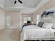 Spacious main bedroom with a tray ceiling, carpeted floor, and natural light at 1635 Lake Heights Cir, Dacula, GA 30019