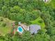 Breathtaking aerial view of private estate featuring a pool, mature trees, and serene pond at 4685 Braselton Hwy, Hoschton, GA 30548