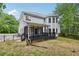 Exterior view showcasing the backyard with a screened porch and mature trees at 4685 Braselton Hwy, Hoschton, GA 30548