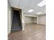 Finished basement with vinyl flooring and a staircase at 4685 Braselton Hwy, Hoschton, GA 30548