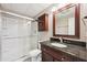 Well-maintained bathroom features a shower with glass doors, a modern vanity, and storage at 4685 Braselton Hwy, Hoschton, GA 30548