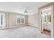 Neutral bedroom featuring a ceiling fan and a doorway to an ensuite bathroom at 4685 Braselton Hwy, Hoschton, GA 30548