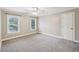 Neutral bedroom with carpeting, a ceiling fan, and windows for natural light at 4685 Braselton Hwy, Hoschton, GA 30548