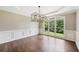 Bright dining room with hardwood floors, elegant trim, and large windows overlooking the yard at 4685 Braselton Hwy, Hoschton, GA 30548