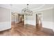 Open concept dining room with hardwood floors and modern light fixtures at 4685 Braselton Hwy, Hoschton, GA 30548