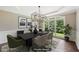Virtually staged dining room with modern light fixture, stylish decor, and large windows at 4685 Braselton Hwy, Hoschton, GA 30548