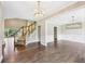 Elegant foyer featuring hardwood floors, staircase, and modern chandelier at 4685 Braselton Hwy, Hoschton, GA 30548