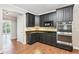 Modern kitchen with granite countertops, stainless steel appliances, and custom cabinets at 4685 Braselton Hwy, Hoschton, GA 30548