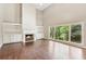 Living room with a fireplace and large windows overlooking the yard at 4685 Braselton Hwy, Hoschton, GA 30548