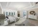 Luxurious main bedroom featuring a tray ceiling, chandelier, and sitting area at 4685 Braselton Hwy, Hoschton, GA 30548
