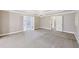 Expansive main bedroom with doors leading to the ensuite bath and walk-in closet at 4685 Braselton Hwy, Hoschton, GA 30548