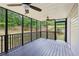 Relaxing screened-in porch with ceiling fans and a view of the backyard at 4685 Braselton Hwy, Hoschton, GA 30548