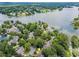 An aerial view of upscale homes next to a lake, with the home for sale marked by a yellow star at 1605 Spinnaker Drive, Alpharetta, GA 30005