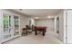 Basement area with a pool table, bar stools, and French doors leading to the outside at 1605 Spinnaker Drive, Alpharetta, GA 30005