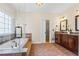 Bathroom with walk-in shower, soaking tub, and double sink vanity at 1605 Spinnaker Drive, Alpharetta, GA 30005
