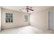 Bedroom with two windows and a ceiling fan featuring neutral walls and soft carpet flooring at 1605 Spinnaker Drive, Alpharetta, GA 30005