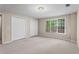 Bedroom with two closets and a large window allowing for ample natural light at 1605 Spinnaker Drive, Alpharetta, GA 30005