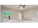 Bedroom with carpet, ceiling fan, and doors to the outdoor deck at 1605 Spinnaker Drive, Alpharetta, GA 30005