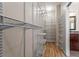 Walk-in closet with wood flooring, metal shelving, and ample storage space at 1605 Spinnaker Drive, Alpharetta, GA 30005