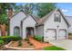 Charming two-story home with landscaped yard, brick walkway, attached two-car garage, and light gray shingle siding at 1605 Spinnaker Drive, Alpharetta, GA 30005