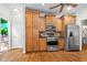 Modern kitchen with stainless steel appliances, granite countertops, custom cabinets, and access to an outdoor patio at 1605 Spinnaker Drive, Alpharetta, GA 30005