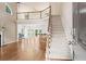 Bright and airy living room with hardwood floors, fireplace, a staircase to the second story, and open access to dining room at 1605 Spinnaker Drive, Alpharetta, GA 30005