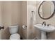 Powder room with white toilet, and pedestal sink at 1605 Spinnaker Drive, Alpharetta, GA 30005